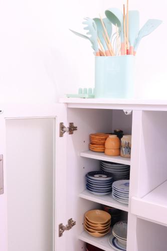 a pantry with plates and dishes on shelves at 二尊院宿坊えんとき in Nagato