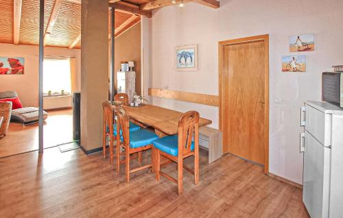 a dining room with a wooden table and chairs at Knueppelhof 1 in Silz