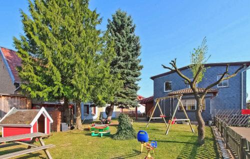 a yard with a playground and a house at Knueppelhof 2 in Silz