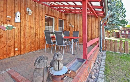 a patio with a table and chairs and a fence at Knueppelhof 2 in Silz
