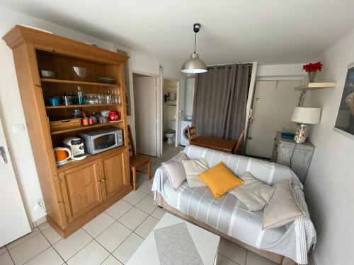 - un salon avec un canapé et un four micro-ondes dans l'établissement Appartement lumineux en centre-ville d'Arcachon, proche commerces, balcon, 4 couchages - FR-1-474-191, à Arcachon
