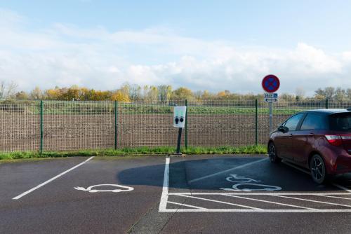 a car parked in a parking lot next to a fence at Campanile Metz Nord - Talange in Talange