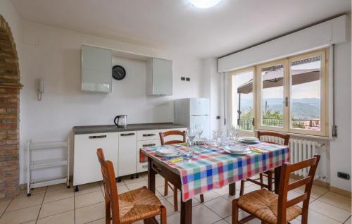 a kitchen with a table with chairs and a table cloth at Casa Alloggio Relax in Montorio al Vomano