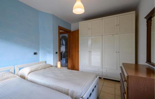 a bedroom with two beds and a dresser and cabinets at Casa Alloggio Relax in Montorio al Vomano