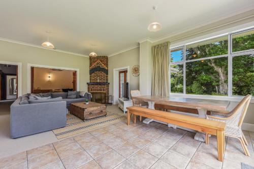 a living room with a couch and a table at Springfields Homestead - Rapaura Holiday Home in Blenheim