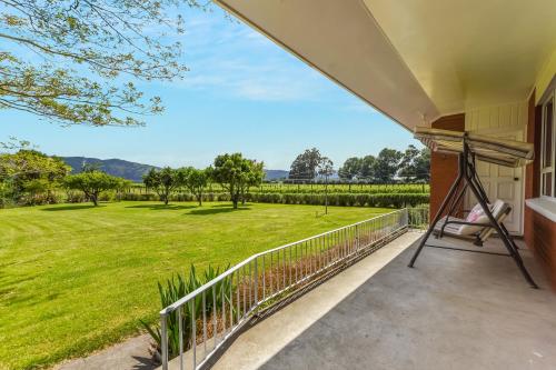 a porch with a view of a green yard at Springfields Homestead - Rapaura Holiday Home in Blenheim