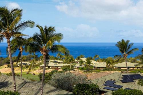 a view of a resort with palm trees and the ocean at ❤PiH❤ Beautiful Ocean Villa Nani Moana Hale Stunning Ocean Views in Hapuna Beach