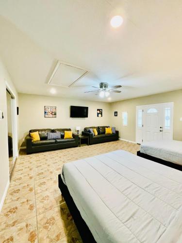 a large bedroom with a bed and a couch at Memorial City Gem Sleeps 12 Fenced Yard in Houston