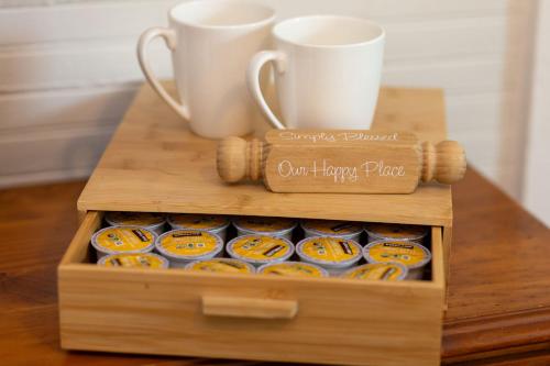a wooden box with cups and donuts on a table at Cozy Downtown Seneca Bungalow in Seneca