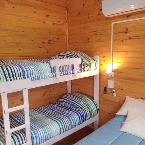 a bunk bed room with two bunk beds in a cabin at Cabaña Don Juan in Villa Elisa