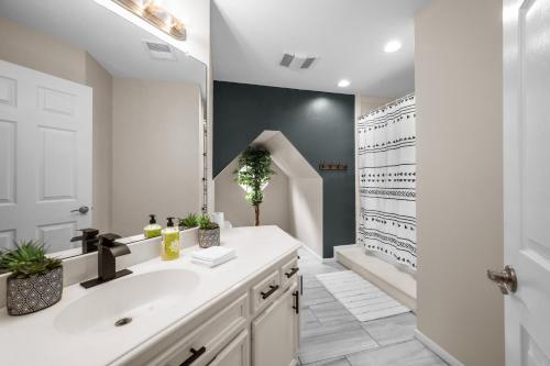 a bathroom with a sink and a mirror at Woodlands Area Lake View Retreat in Conroe