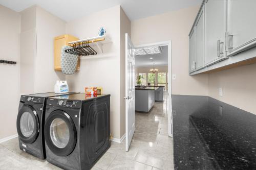 a laundry room with a washer and dryer at Woodlands Area Lake View Retreat in Conroe