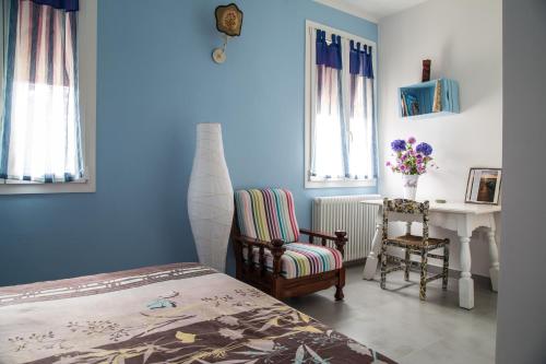 a bedroom with a bed and a chair and a desk at B&B Ai Prati in Monestirolo
