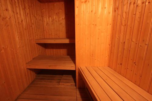 a wooden sauna with two wooden shelves in it at Belle Isle Sur Risle - Chateau Hotel & Spa in Pont-Audemer