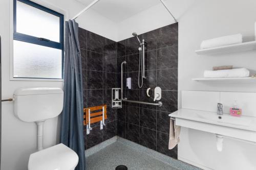 a bathroom with a toilet and a shower at Panorama Motor Lodge in Timaru