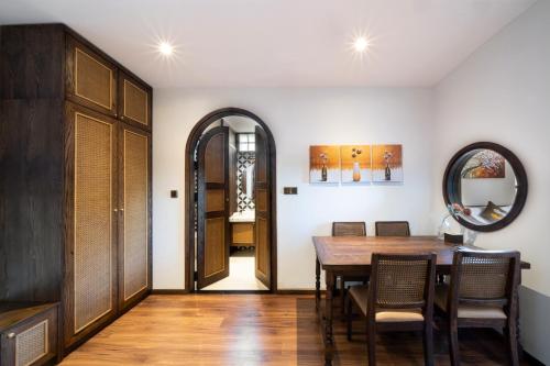 a dining room with a table and chairs and a mirror at Hoi An Emotion Boutique Villa in Hoi An