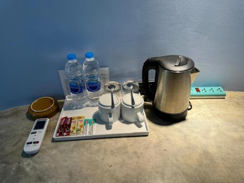 a coffee maker and a tea kettle and water bottles at Koh Mak Buri Hut Natural Resort in Ko Mak