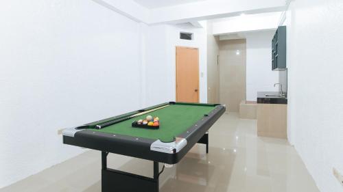 a pool table with balls on it in a room at RedDoorz Plus near Tambo Paranaque in Manila