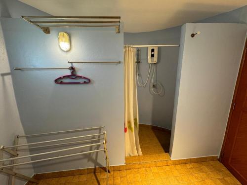 a bathroom with a shower and a shower curtain at Koh Mak Buri Hut Natural Resort in Ko Mak
