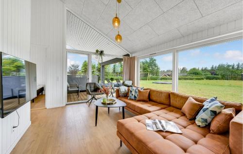 a living room with a couch and a table at 4 Bedroom Beautiful Home In Hemmet in Hemmet