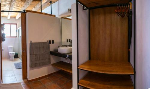 a bathroom with a sink and a toilet and a mirror at Villa Mosaico - Luxury Lofts in Real de Catorce