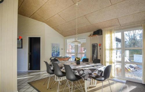 a dining room with a table and chairs at Nice Home In Glesborg With Sauna in Fjellerup Strand
