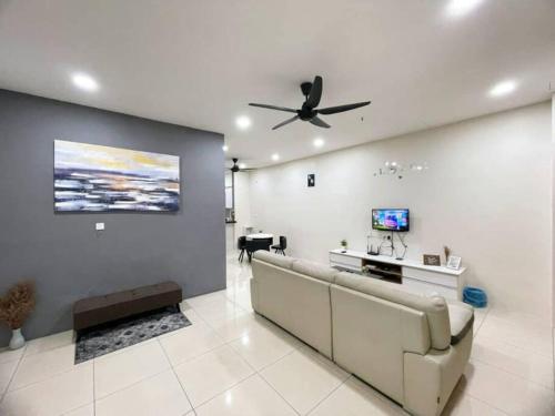 a living room with a couch and a ceiling fan at CozyHouse 4ROOM 3BATH ROOM 10PAX```SimpangAmpatTasek in Simpang Ampat