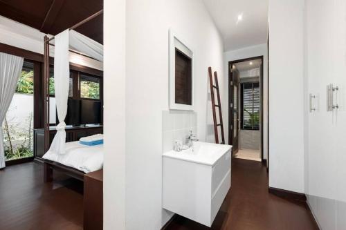 a white bathroom with a sink and a bed at Renovated Luxury 3 Bed Pool Villa Kirikayan Maenam Koh Samui in Amphoe Koh Samui