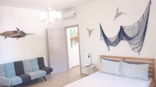 a bedroom with a bed and a couch at Villa Chimera in Pachino