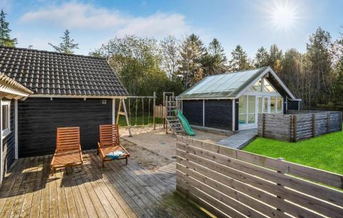 einen Hinterhof mit einem Schuppen und einem Spielplatz in der Unterkunft Awesome Home In Hals With Sauna in Hals