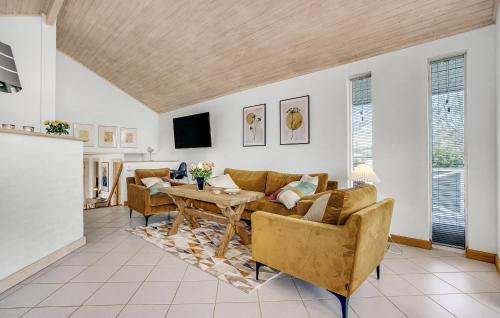 a living room with a couch and a table at Beautiful Home In Strøby With Wifi in Strøby
