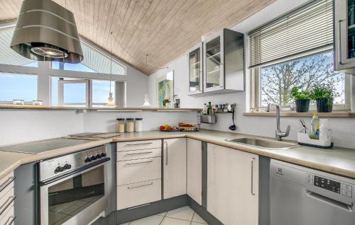 a kitchen with white cabinets and a sink at Beautiful Home In Strøby With Wifi in Strøby