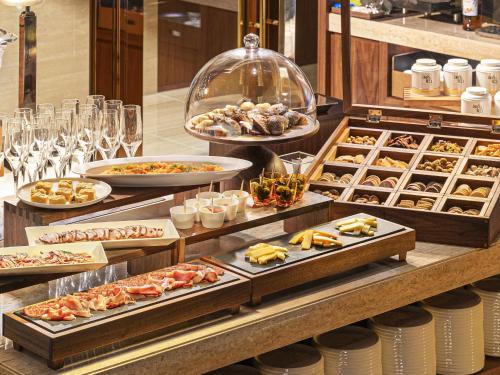 a buffet with many different types of food on display at Candeo Hotels Osaka The Tower in Osaka