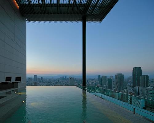 a swimming pool on the roof of a building at Candeo Hotels Osaka The Tower in Osaka