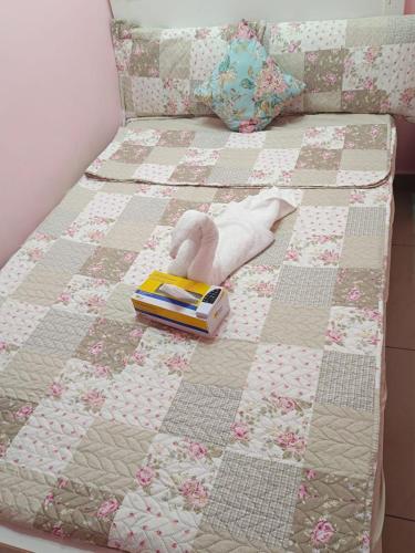 a bed with a quilt and a toy on it at DraGon Executive Homes 002 in Dubai