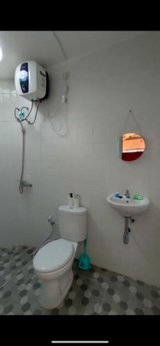 a bathroom with a toilet and a sink at Kusumanagara Dome1 in Panjadakan