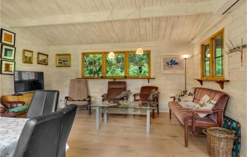 a living room with a couch and a table at Two-Bedroom Holiday Home In Herning in Herning