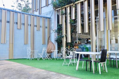 a group of tables and chairs in front of a building at The Resort Angel Hill in Ban Khlong Phai