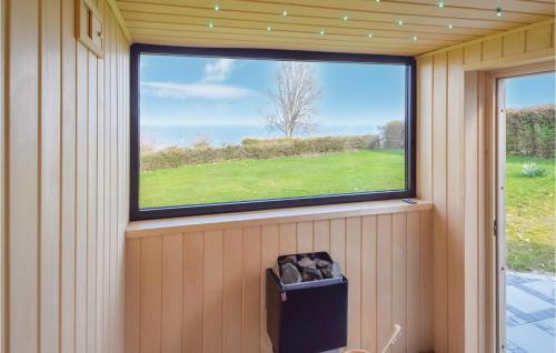 a window in the corner of a room with a trash can at Three-Bedroom Holiday Home In Borkop in Børkop