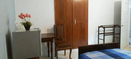 a bedroom with a desk and a table and a bed at Crescent N Cocoon in Ambalangoda