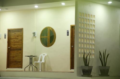 a bathroom with a mirror and a table and a chair at บ้านศรีสุธรรม 2 Baansrisuthum 2 in Surat Thani