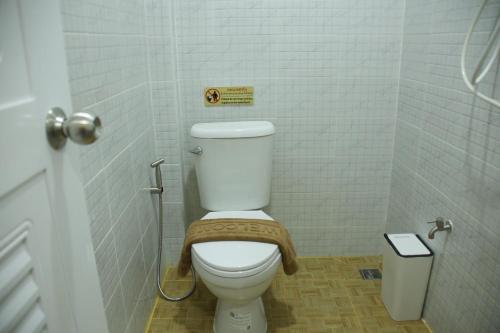 a bathroom with a white toilet in a stall at บ้านศรีสุธรรม 2 Baansrisuthum 2 in Surat Thani
