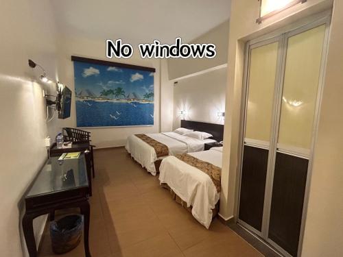 Postel nebo postele na pokoji v ubytování Pontian Garden Hotel