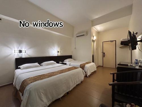 Кровать или кровати в номере Pontian Garden Hotel