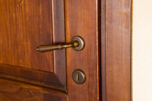 a wooden door with a brass door knocker on it at I Costanti in Caldiero