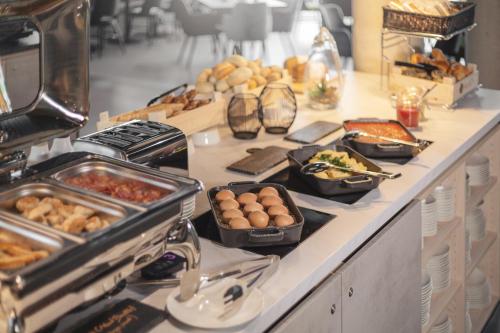 a buffet with many different types of food on a counter at Candlewood Suites Augsburg in Augsburg
