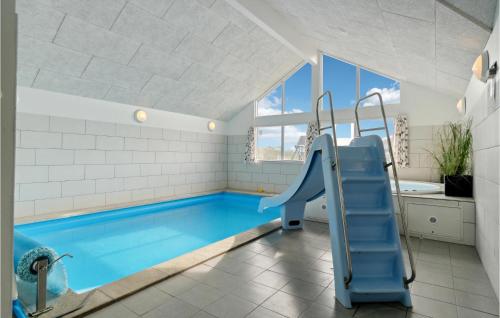 a bathroom with a swimming pool and a slide at Awesome Home In Hvide Sande With Sauna in Havrvig