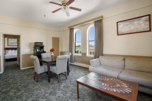 a living room with a couch and a table at Hotel St. Michael, BW Premier Collection in Prescott