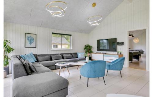 a living room with a couch and a table at Holiday Home Frederiksværk With Fireplace 03 in Frederiksværk