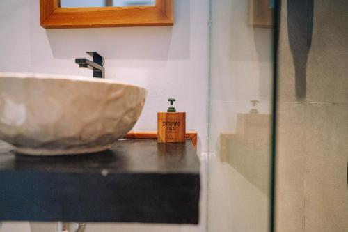 a bathroom with a sink on a counter at Susurro Villas in Kuta Lombok